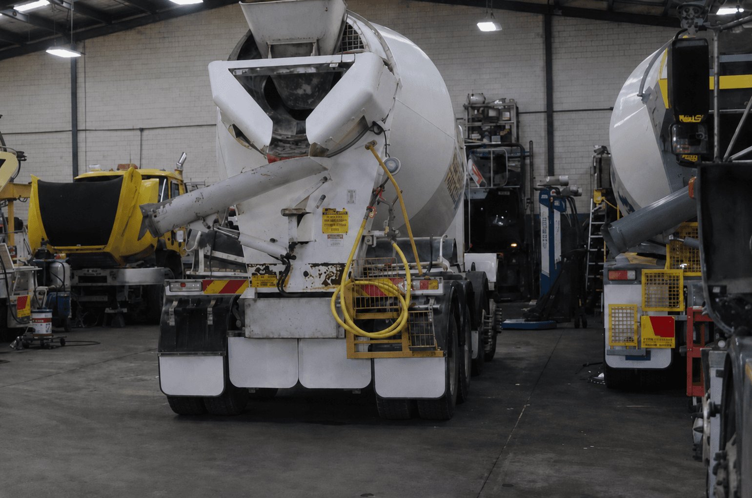Concrete mixer trucks in the workshop for repair